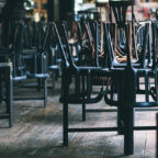 Chairs and tables stacked in a closed pub